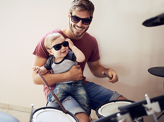 Image showing Cool father, baby sunglasses and drummer musician with music development and child learning. Home, happiness and dad with youth drumming lesson with smile, love and parent care at a family house