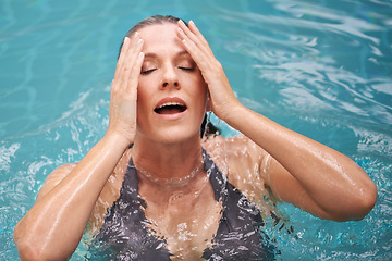 Image showing Swimming, water and woman in pool on holiday, summer vacation and weekend getaway. Travel, spa resort and female person swim for exercise, wellness and luxury at hotel for happiness, freedom and fun