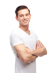 Image showing Arms crossed, happy and smile with portrait of man in studio for confident, positive and casual. Trendy, fashion and face with male model isolated on white background for happiness, natural and cool