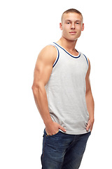 Image showing Man, confident smile and portrait with fashion and modern style in studio. White background, jeans and young male model with muscles and clothing with youth and attitude feeling cool with confidence