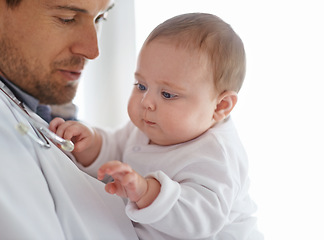 Image showing Doctor, pediatrician and baby playing with stethoscope for healthcare assessment, medical support and growth. Newborn kids, man and pediatrics service in clinic, hospital and playful children