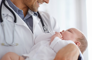Image showing Doctor, pediatrician and holding baby in arms for hospital assessment, medical support and growth. Pediatrics, happy physician and carrying newborn kid in clinic, healthcare service and help children