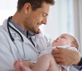 Image showing Happy male doctor, pediatrician and holding baby for hospital assessment, medical support and growth. Pediatrics, physician and carrying newborn kid in clinic, healthcare service and helping children