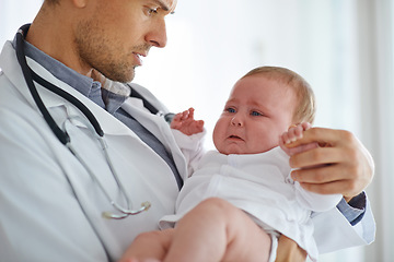 Image showing Doctor, pediatrician and crying baby in clinic for medical assessment, support and growth. Sad, scared and sick newborn kid with pediatrics physician for healthcare service, hospital test or wellness