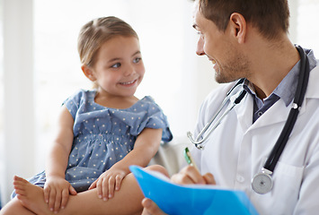 Image showing Happy, child and pediatrician writing in clinic for healthcare consulting, wellness consultation and checkup. Medical doctor, girl kid and notes of assessment report, analysis and results in hospital