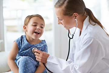 Image showing Child, happy pediatrician and stethoscope for healthcare consulting, check lungs and listening to heartbeat. Woman, medical doctor and girl kid in clinic for chest assessment, analysis and checkup