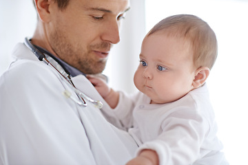 Image showing Doctor, pediatrician and holding baby for healthcare assessment, medical support and growth. Newborn kids, man and pediatrics service in clinic, hospital or expert consulting for wellness of children