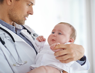 Image showing Doctor, sick and sad baby in clinic for healthcare assessment, pediatrics support and help. Pediatrician holding unhappy newborn kid for hospital service, medical test and wellness of crying children