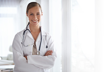 Image showing Portrait of happy woman, arms crossed and doctor in hospital for healthcare, wellness and clinic services. Female medical employee, professional therapist and smile for trust, integrity and mockup