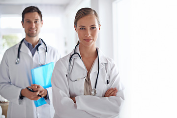 Image showing Portrait of woman, arms crossed and team of doctors in hospital for healthcare, management and clinic services. Medical employees, surgery manager and collaboration for support, trust and checkup