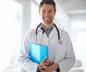 Image showing Portrait of happy man, doctor and folder in hospital for healthcare management, clinic services and report. Male medical employee, professional therapist and smile for confidence, trust and integrity