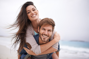 Image showing Hug, beach and portrait of couple piggyback with love, smile and laugh while bonding outdoor. Face, embrace and happy man with woman at the ocean for travel, freedom or vacation, holiday or Bali trip