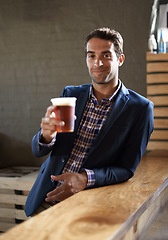 Image showing Professional man at pub, happy with beer in portrait and cheers, relax and leaning against countertop in bistro. Hospitality industry, male business person at restaurant with alcohol drink and smile