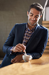 Image showing Professional man at cafe, happy with coffee and relax on a break and leaning against countertop. Hospitality industry, male business person at restaurant with smile on face and stirring drink