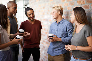 Image showing Coffee, friends and students talking in a college hallway for discussion, happiness and a drink. Group of diversity men and women at campus or university for conversation about education and learning