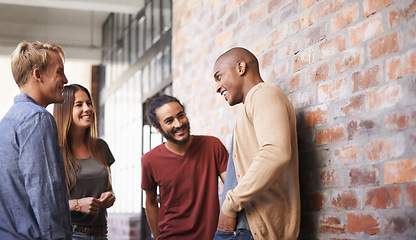 Image showing Talking, laughing and college friends or students in a hallway for a happy discussion. Group of diversity men and a woman at campus or university for a funny conversation about education career