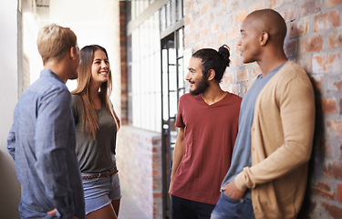 Image showing College, friends or students talking in a hallway for discussion, happiness or a chat. Group of diversity men and a woman at campus or university to talk about education, learning or school work