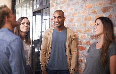 Image showing Talking, friends or students in a college hallway for discussion, happiness and a chat. Group of diversity men and women at campus or university for conversation about education career or school work