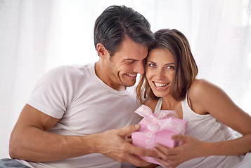 Image showing Couple, gift or hug for valentines day portrait celebration with love, care and surprise in bedroom. Man and happy woman in home with box for birthday, holiday or luxury with smile for gratitude