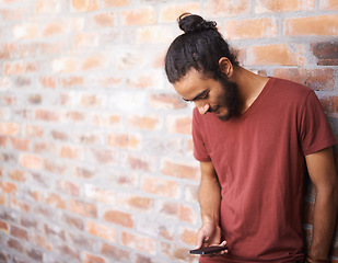 Image showing School, phone and university with man at brick wall space for social media, technology or internet. Eduction, learning and scholarship with male student on college campus for connection and contact