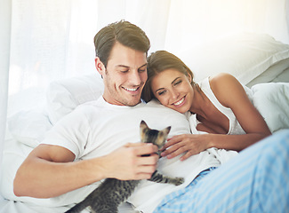 Image showing Bedroom love, pet cat and happy couple relax for morning peace, calm and bonding quality time together in Toronto Canada. Flare, animal kitten and romantic people smile in home bed for Valentines Day