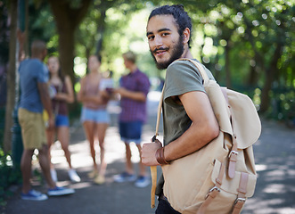 Image showing Man walking, student and portrait with backpack by a campus park with a smile and ready for study. Happiness, young and male face in college and university outdoor with education and school bag