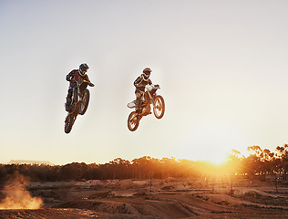 Image showing Adventure, speed and motorbike for a competition during a race outdoor for extreme sports. Action, men and motorcycle on racetrack for sport jump on fast transportation in the dirt with sunset.