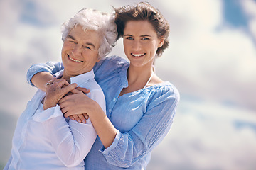 Image showing Woman, senior mother and portrait by sky with hug, happiness, love or smile for mothers day on vacation. Elderly lady, daughter or happy with care, bond or outdoor by clouds for holiday in retirement