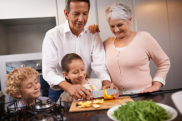 Image showing Food, grandparents or happy kids learning cooking skills for a healthy dinner with fruit or vegetables at home. Teaching, child development or grandmother with old man or meal nutrition in kitchen