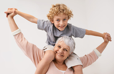 Image showing Portrait, airplane and grandmother with child embrace, happy and bonding against wall background. Love, face and senior woman with grandchild having fun playing, piggyback and enjoying game together