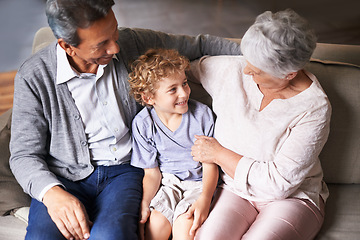 Image showing Boy, relax or happy grandparents with a child talking, laughing or hugging with love in family home. Elderly grandma, old man or kid relaxing, bonding or enjoying quality time together in retirement