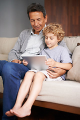 Image showing Tablet, child or grandpa streaming movie or film on online subscription in retirement at home to relax. Family, grandfather or kid loves watching fun videos with a senior or mature old man on sofa