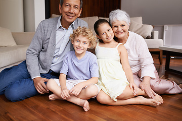 Image showing Portrait, floor and happy grandparents with children, sit and smiling together in retirement family home. Senior grandma, smile or kids siblings relaxing or bonding to enjoy quality time with old man