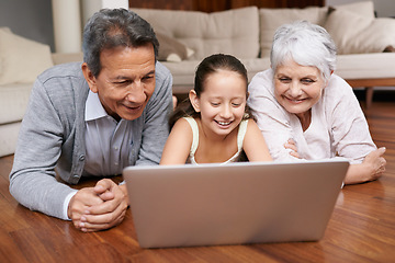 Image showing Laptop, floor or grandparents with girl for movie streaming online subscription in retirement at home together. Child, relaxing or happy grandmother loves watching fun videos with a senior old man