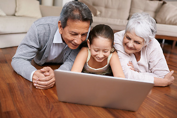 Image showing Laptop, floor or grandparents with happy child for movie streaming online subscription in retirement at home. Girl, relaxing together or grandmother watching videos on internet with a senior old man