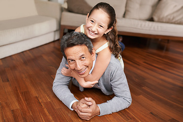 Image showing Portrait, piggyback or happy grandpa with a child on the floor playing or hugging with love in family home. Elderly grandfather, kid or old man relaxing or bonding to enjoy quality time in retirement