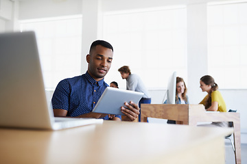 Image showing Business, startup or black man reading on tablet working on digital marketing strategy in office. SEO social media content, laptop technology or employee researching online for info on internet site