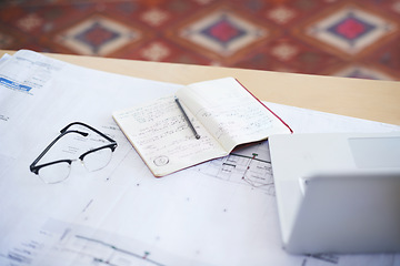 Image showing Notebook, laptop and blueprint on desk for architecture planning, strategy or layout at the office. Paperwork for building or floor plan of architect construction notes, ideas or design on workspace