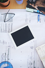 Image showing Tablet, blueprint and mockup on office desk above for architecture planning, strategy or layout. Top view of building paperwork, floor plan or architect notes in construction with tech screen display