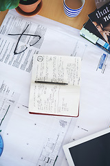 Image showing Notebook, blueprint and writing on office desk above for architecture planning, strategy or layout. Top view of building paperwork, floor plan or architect notes for construction, ideas or design