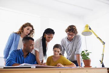 Image showing Diversity, business people and documents in planning, brainstorming or design strategy at the office. Group of diverse employees working together on paperwork in teamwork collaboration at workplace