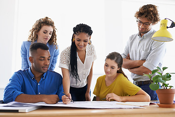 Image showing Diversity, business people and writing on documents in teamwork planning, strategy or collaboration at the office. Group of diverse employees working on paperwork in team brainstorming at workplace