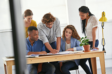 Image showing Diversity, business people and writing with documents for planning, teamwork or collaboration at the office. Group of employees in meeting working on paperwork together for project plan at workplace