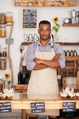 Image showing Black man, portrait and waiter with arms crossed in cafe with pride for career or job. Barista, serious and confidence of African person from Nigeria in restaurant, small business and coffee shop.