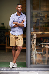 Image showing Coffee shop, arms crossed and man as small business owner at door thinking of future ideas. African entrepreneur, manager or restaurant waiter with smile for service, career pride and confidence