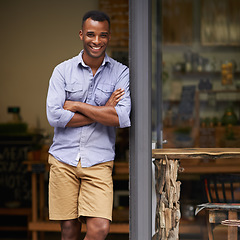 Image showing Portrait, coffee shop and black man as small business owner at front door with a smile. Entrepreneur person as barista, manager or waiter in restaurant for service, career pride and startup goals