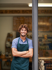 Image showing Owner, arms crossed or portrait of man at restaurant for small business, coffee shop or waiter. Entrepreneur, happy smile and male barista at front door of cafe for diner and food industry confidence