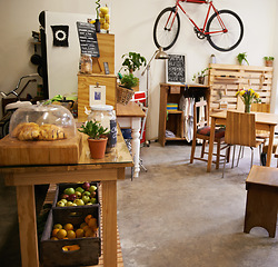 Image showing Interior, space and empty coffee shop with table, chairs and furniture or small business, bistro or cafe with unique design and style. Background, restaurant startup or food counter with bike on wall