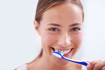 Image showing Woman, portrait and brushing teeth in bathroom with smile, health and self care for oral hygiene, wellness and routine. Girl, toothbrush and happiness for cleaning, healthy mouth and start morning