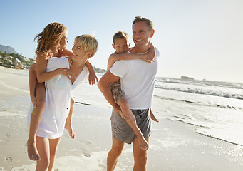 Image showing Family, beach and walking piggyback of mother, father and carrying kids together outdoor in fun nature. Sea, smile and happiness with bonding, parent support and love laughing by the ocean on holiday